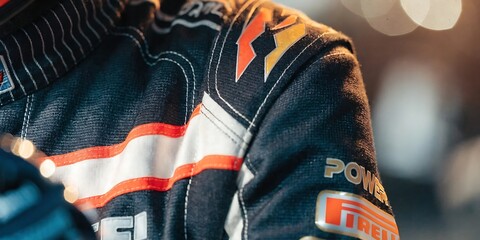 Obraz premium Detail of a professional formula one driver fireproof racing suit with sponsor logos and stitch