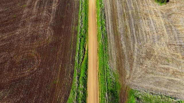 Aerial video flying over cultivated farmland near Gunnedah, NSW, Australia. The cultivated soil forms striking geometric patterns and textures
