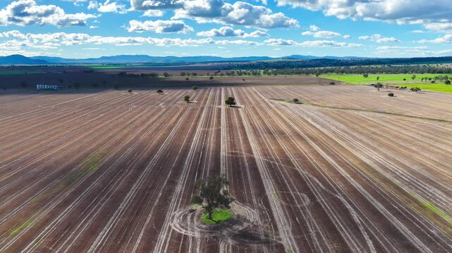 Aerial video flying over cultivated farmland near Gunnedah, NSW, Australia. The cultivated soil forms striking geometric patterns and textures
