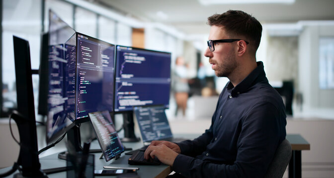 Young Software Engineer Coding Algorithm On Laptop