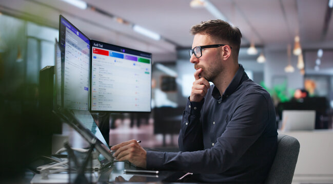 Man Reviews Software Dashboard Using Touchscreen