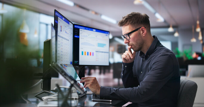 Man Efficiently Using Dual Touchscreen Laptops