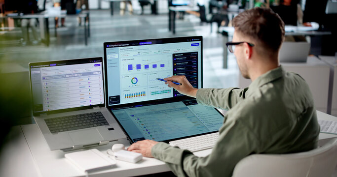 Customer Service Manager Reviews Complaint Dashboards Using Laptop