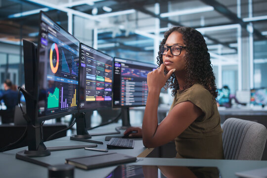 Young African American Woman Uses Cybersecurity Software To Scan Computer
