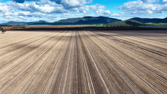 Aerial video flying over cultivated farmland near Gunnedah, NSW, Australia. The cultivated soil forms striking geometric patterns and textures
