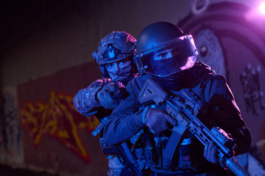 SWAT Tactical Officers Armed With Rifles and Pistol During Night Urban Operation and Raid