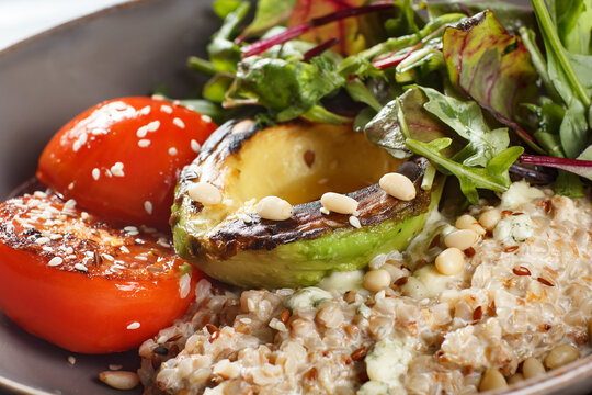 Grilled avocado and roasted tomato salad bowl with vegetarian, nutrition