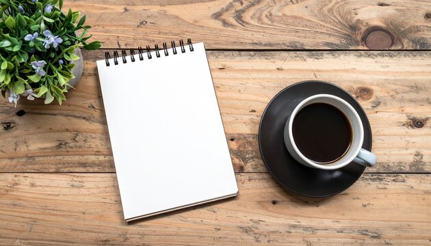 blank notebook beside coffee cup