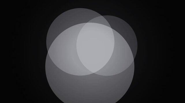 Abstract overlapping translucent circles slowly animate on a dark background design