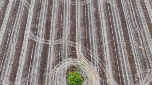 Aerial video flying over cultivated farmland near Gunnedah, NSW, Australia. The cultivated soil forms striking geometric patterns and textures