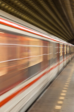 Motion Blurred Metro Train Arriving at Underground Station, Dynamic Urban Public Transport Scene with Speed Effect, Modern Rail Transit and City Mobility Concept