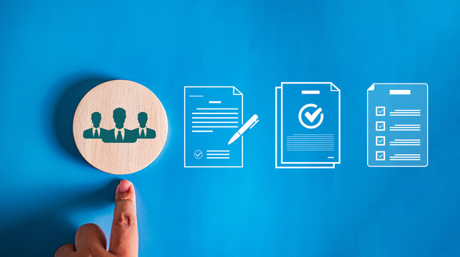 Hand pointing to wooden block with people icon next to virtual document agreement, contract, and checklist icons, concept of team onboarding and HR compliance