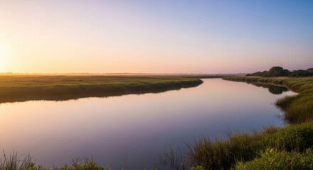 Fototapeta premium Tranquil marsh waterway reflecting soft dawn hues of sunrise across expansive natural wetlands evoking peace and serene natural beauty during a golden hour.