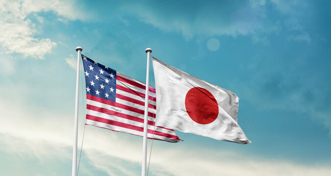 United States and Japan friendship flags are waving in the sky. Two country flag for agreement or deal. American Japan national flag for commitment. 4th july happy independence day of america.