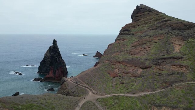 Drone aerial right to left reveal shot of dramatic volcanic sea stacks in Madeira