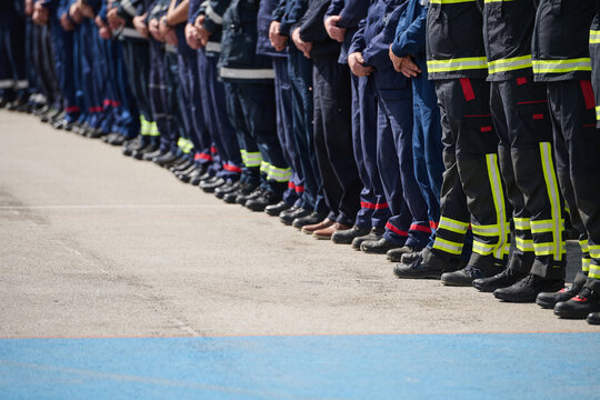 Line Of Firefighters And Emergency Crew Standing In Uniforms During Ceremony Or Drill