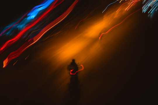 Light trails from traffic in Bangkok at night create a vibrant urban scene