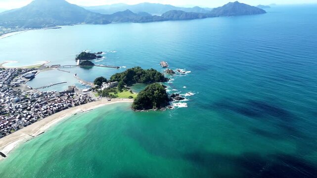 Wide panoramic view of the picturesque coastal landscape, rocky shores, and tranquil waters of Wakasa Wan Quasi-National Park, Japan