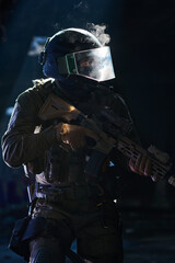 Obraz premium Armed Tactical Soldier In Riot Helmet Holding Assault Rifle During Low-Light Urban Operation