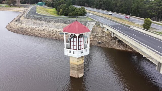 Aerial view of reservoir intake tower and highway bridge