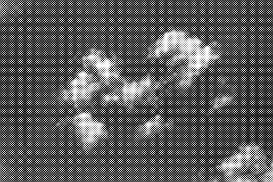 Abstract clouds rendered in black and white halftone dot pattern