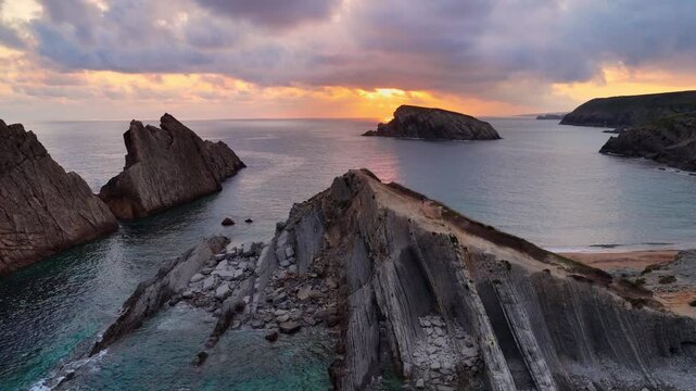 sunrise aerial view on the Atlantic coast of Cantabria, Spain, drone shot of Arnia beach in Dunas de Liencres natural park, scenic nature, rocky coast of Cantabria, travel in northern Spain