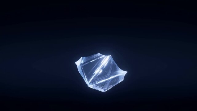Slow motion tracking of glowing crystal rotating and drifting inward in dark studio void with blue highlights