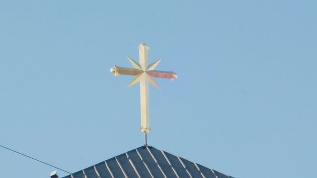 Close-up shot of the Scientology cross and signage in Los Angeles, bright daylight exterior.