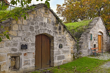 Obraz premium Traditional Stone Wine Cellars With Grass Roofs In Purbach Austria