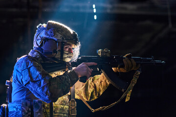 Fototapeta premium Tactical Soldier Aiming Assault Rifle in Low Light Combat Training With Camouflage Gear and Helmet
