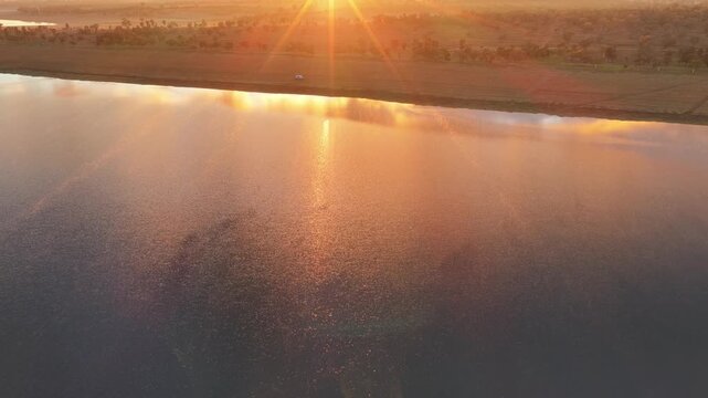 Aerial video flying over Lake Keepit Dam and the surrounding landscape in NSW, Australia. The expansive reservoir, dam wall and rolling countryside