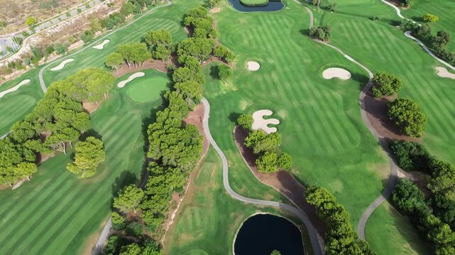 stunning aerial perspective over an exclusive luxury golf club showcasing vibrant green fairways challenging sand traps meandering cart paths water hazards and dense trees for elite outdoor recreation