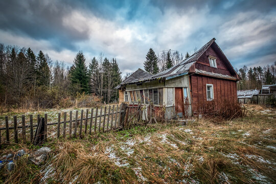 Abandoned and dilapidated old wooden log houses in a remote forest village of Karelia, Russia