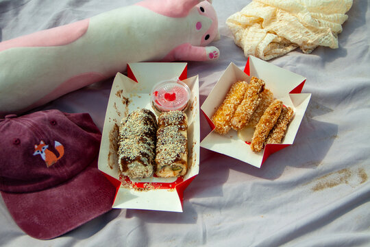 Fried Cheese Sticks and Plush Toy on Picnic Blanket