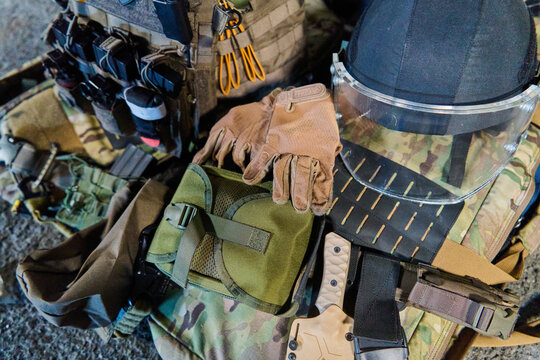 Tactical Military Gear Laid Out With Helmet Gloves Plate Carrier And Accessories