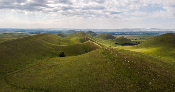 Aerial landscape view over Dolgiye Mountains in the Orenburg region, Russia. Hilly terrain, mountain fields. The beginning of the Ural Mountains.
