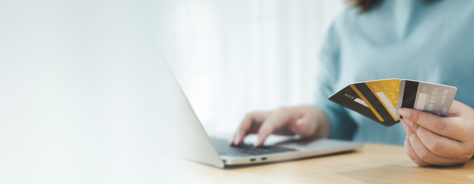 Online payment , female hands holding credit cards and using smartphone for shopping online with payment on internet banking.