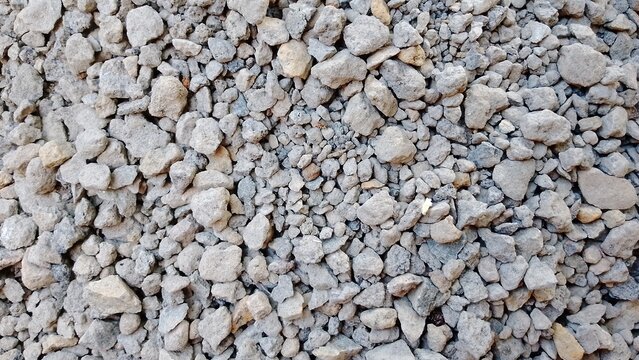 Close-up of textured gravel surface for construction or landscaping. Natural stone detail for outdoor design projects.
