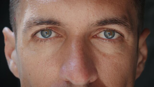 Extreme close up of male eyes shows real emotion authenticity and humanity. Natural skin texture and direct gaze express honesty realism and true character for documentary and storytelling use.