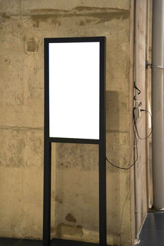 blank framed sign in front of boutique shop