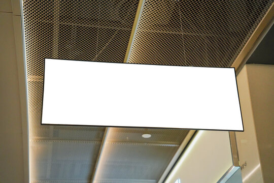 Mockup of a sign hanging from the ceiling of the hall for displaying work, graphics and various forms of media.
