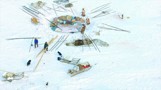 Aerial view of a Nenets nomad family setting up camp in a snowy landscape in Siberia