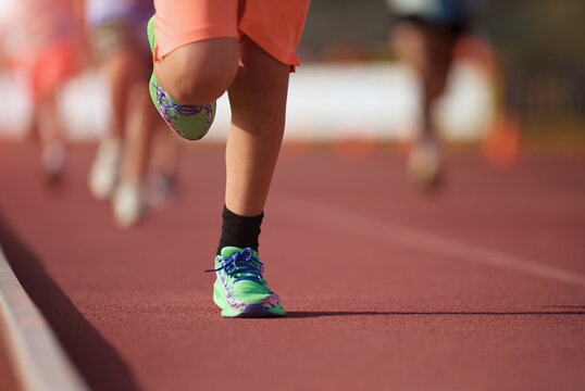 Childs running in stadium. Kids run on outdoor track. Young athlete training. Jogging for kid, training and children sport healthy lifestyle concept