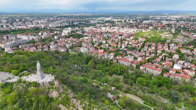Aerial drone view of the Plovdiv cityscape with Bunardzhik Hill. Scenic panoramic view of one of the oldest cities in Europe, surrounded by lush green hills. Bulgaria.