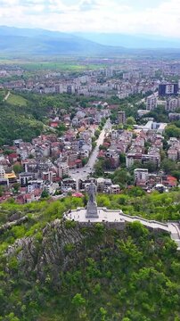 Aerial drone view of the Plovdiv cityscape with Bunardzhik Hill. Scenic panoramic view of one of the oldest cities in Europe, surrounded by lush green hills. Bulgaria.