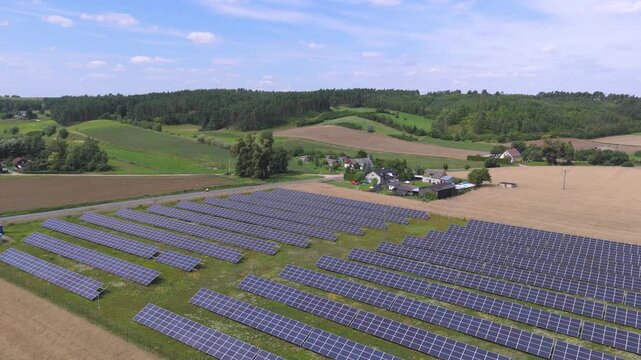 Aerial Drone Shot of a Solar Farm Near a Rural Village Highlighting Green Energy, Sustainability, and Renewable Infrastructure