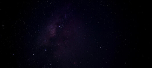 Night sky astrophotography of milky way galaxy core with purple and blue nebula clouds Thousands of stars on black sky. Background for astronomy,  space exploration, science and nature concepts. © Darth Fobie