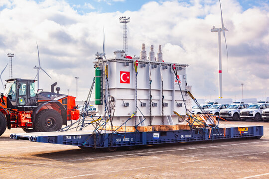 Amsterdam, Netherlands - July 20, 2026: Heavy industrial Astor transformer secured on flat rack platform at port terminal