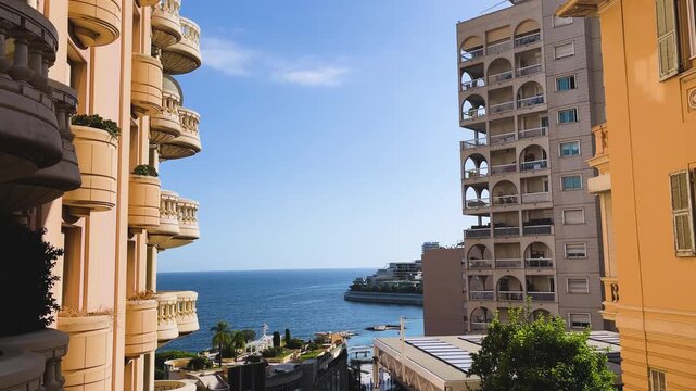 Sunlit Mediterranean view framed by luxury apartment buildings and ornate balconies in Monaco, highlighting the principality&rsquo;s elegant coastal architecture.