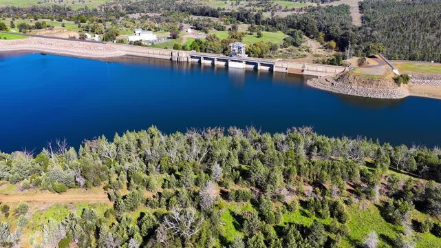 Aerial video flying over Lake Keepit Dam and the surrounding landscape in NSW, Australia. The expansive reservoir, dam wall and rolling countryside